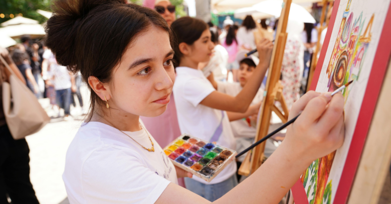 support youth art competitions in underserved areas